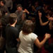 Members of a full-house audience dance