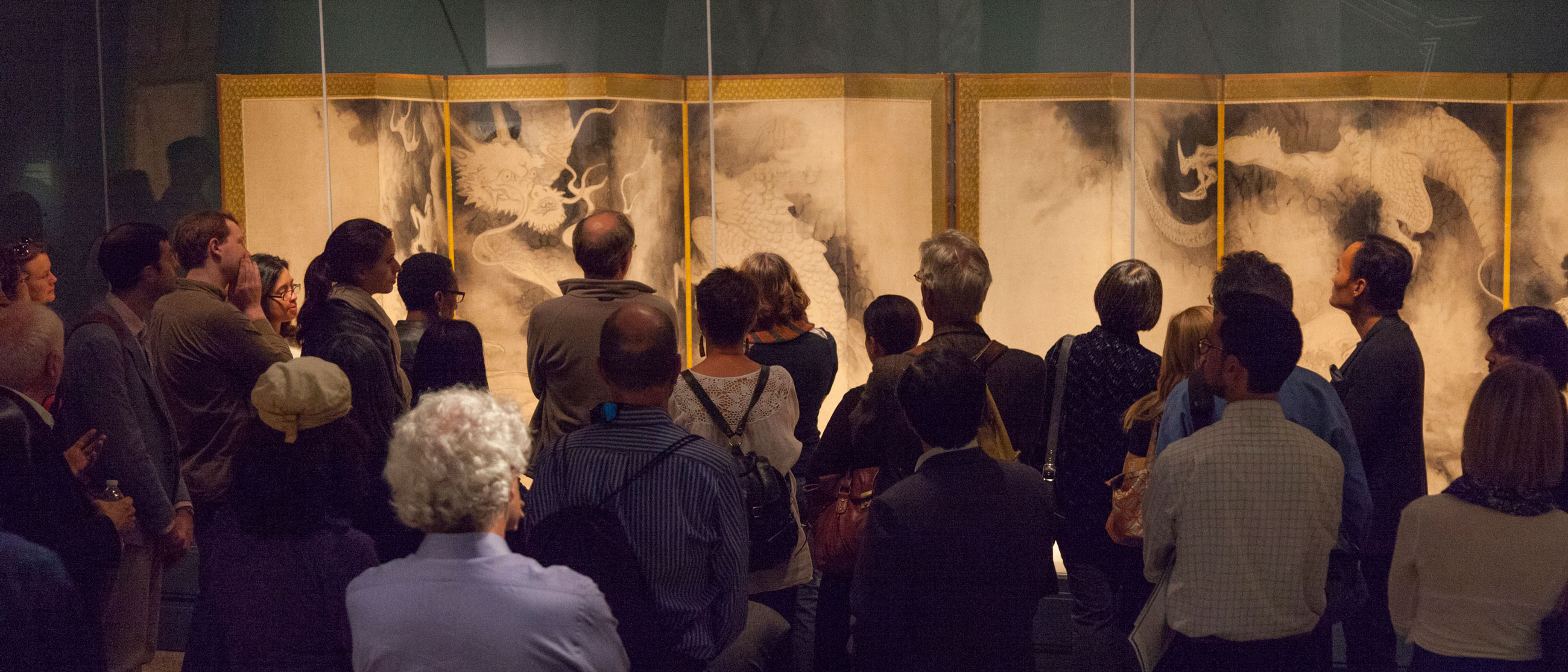 visitors view a screen in the exhibition Sotatsu