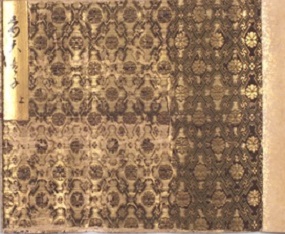 The acidic silk threads have darkened and are flaking off the surface of the fabric, exposing the gold threads beneath